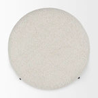 Pouf rotondo in tessuto bouclé color crema con base in metallo nero