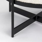 Pouf rotondo in tessuto bouclé color crema con base in metallo nero